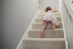 Rear,View,Of,A,Little,Girl,Climbing,Up,The,Stairs